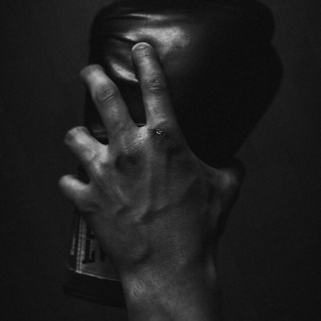 Grayscale Photo of Person Holding Boxing Glove